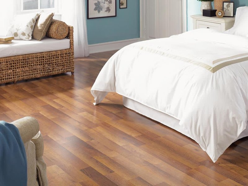 A bedroom with a hardwood floor